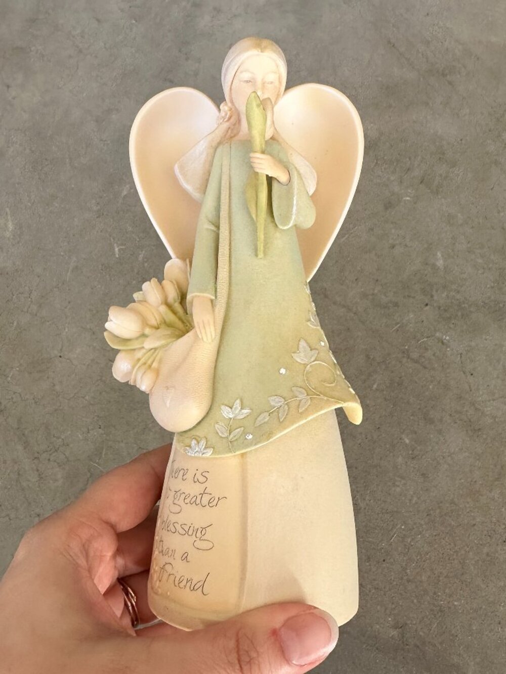 Angel figurine with flower and inspirational quote